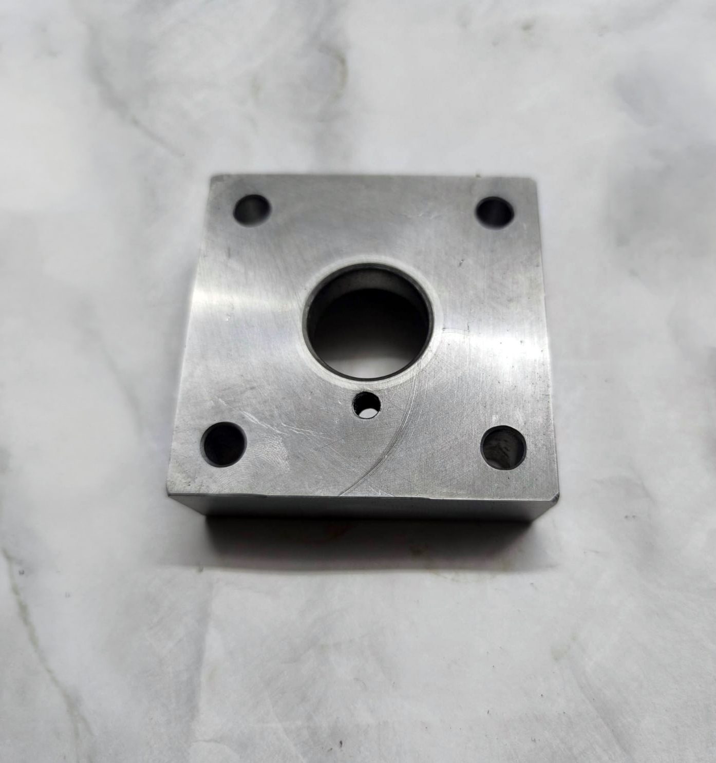 Precision machined steel block prototype — front view